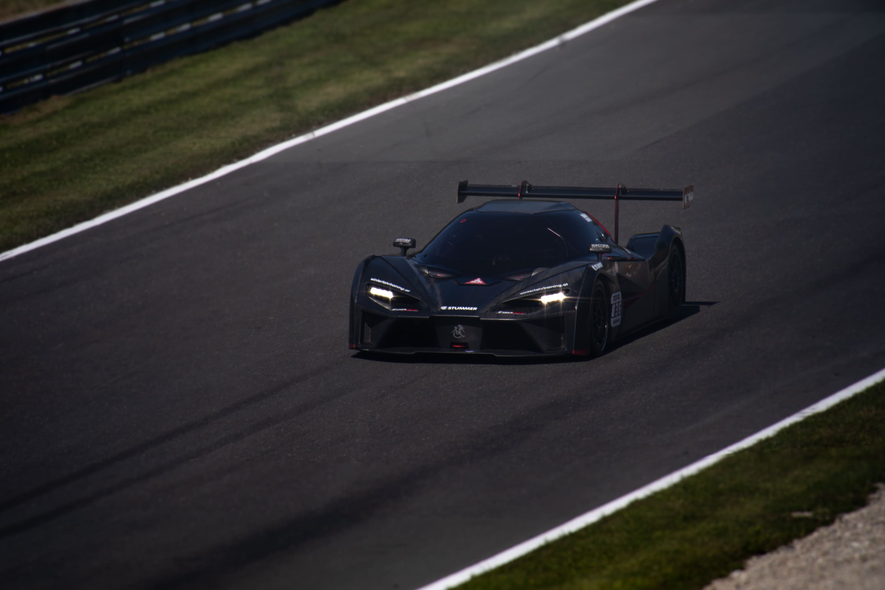 Schwarzer KTM X-Bow GT2-Rennwagen auf der Rennstrecke
